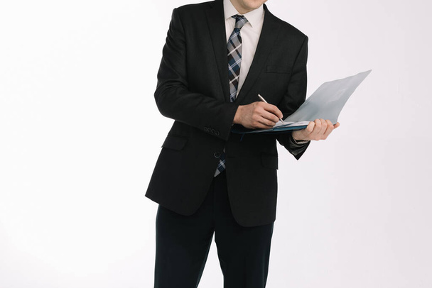 business document. business man, writing on a tablet on a blank sheet. A businessman in a businessman's suit signs a document on a white background. - Foto, Imagem