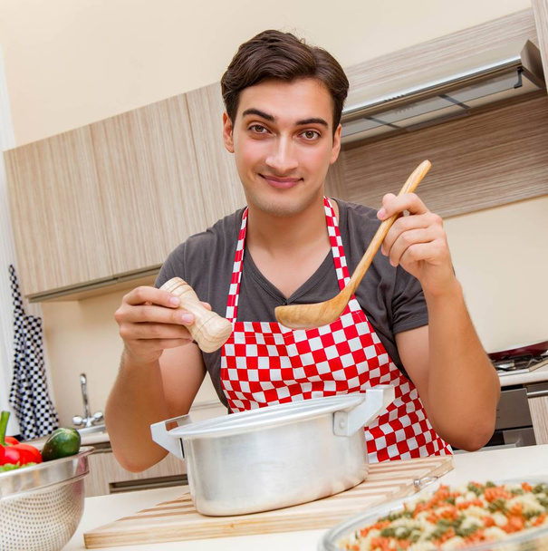 Άντρας μάγειρας ετοιμάζει φαγητό στην κουζίνα - Φωτογραφία, εικόνα