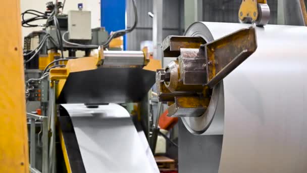 Steel sheet is wound on a roll on a special machine. Packed rolls of steel sheet, Cold rolled steel coils. - Footage, Video