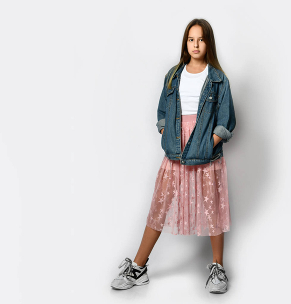 Young smiling teen girl in stylish casual clothes, sneakers and pink sunglasses standing and looking at camera - Valokuva, kuva