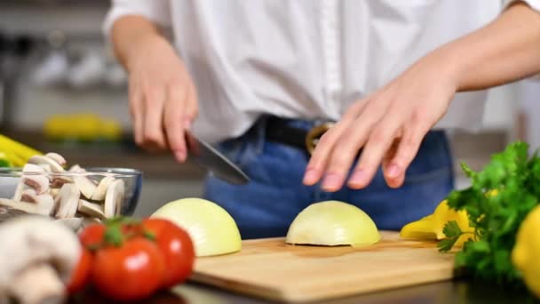 Woman is cutting tomatoes on cut board on kitchen in slow motion. Fresh vegetables for salad - Filmmaterial, Video