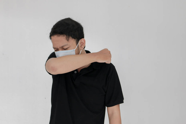Suffering young asian man in mask - Фото, зображення