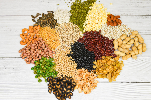 Set of different whole grains beans and legumes seeds lentils and nuts colorful snack texture background / Various beans mix peas agriculture of natural healthy food for cooking ingredients - Fotografie, Obrázek