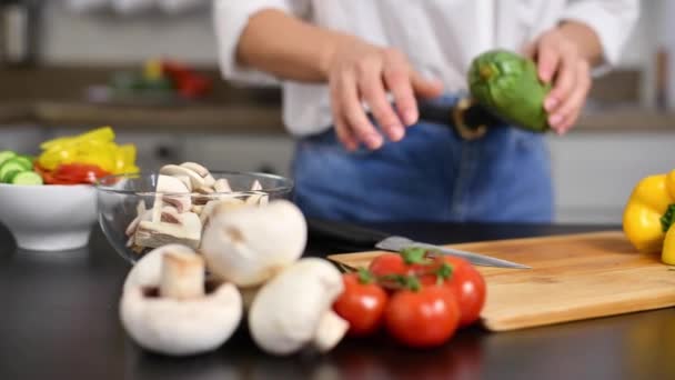 Woman is cutting tomatoes on cut board on kitchen in slow motion. Fresh vegetables for salad - Video