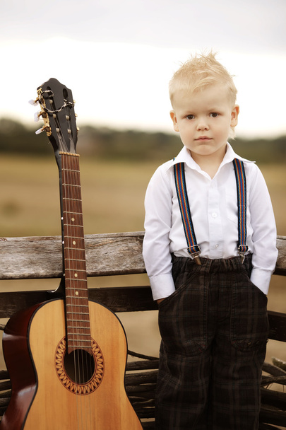 cute little boy with guitar - Foto, imagen
