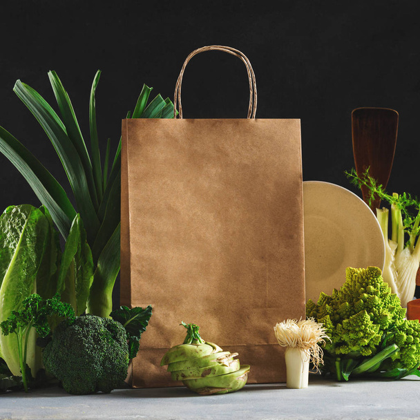 Still life Paper bag with different health food on dark background - Photo, image