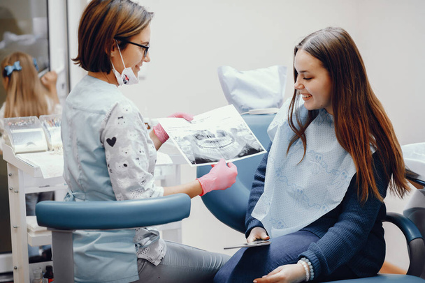 Beautiful girl sitting in the dentists office - 写真・画像