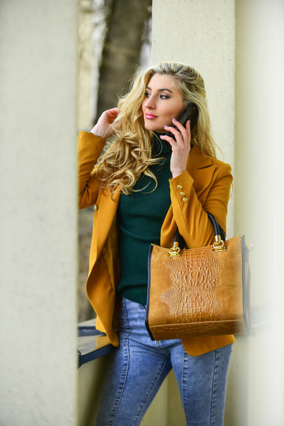 phone conversation. Fashion fall portrait of trendy woman. posing on the street. Fashion photo of young stylish woman. Catalogue clothes and accessories. Lookbook. sexy carefree woman with blond hair - Photo, Image