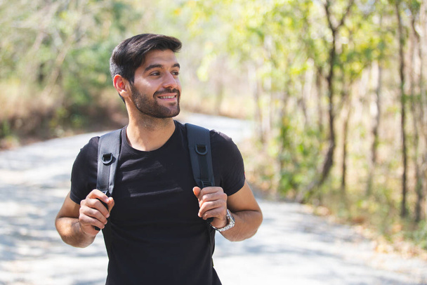 portrait man smile looking camera with backpack in nature travel. - Foto, Imagen