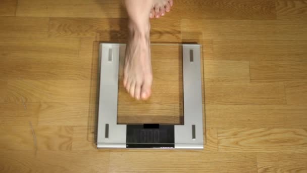 Vrouw Checking Gewicht op een digitale schaal, bovenaanzicht. - Video