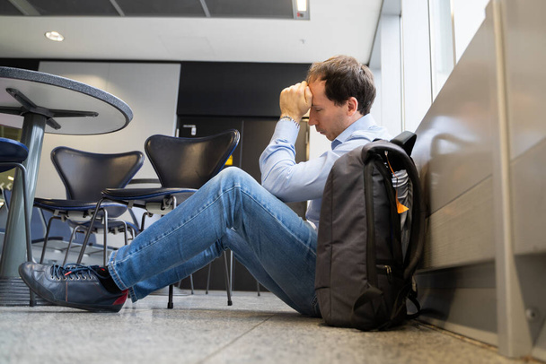 Flight Delay And Cancellation. Upset Man In Airport.  - 写真・画像
