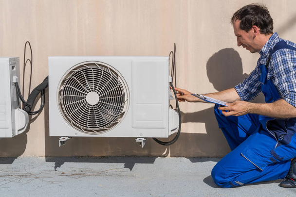 Homme faisant le chauffage, la ventilation et l'inspection de la climatisation
 - Photo, image