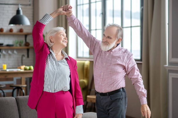 Happy elderly couple dancing and enjoying their day - Photo, image