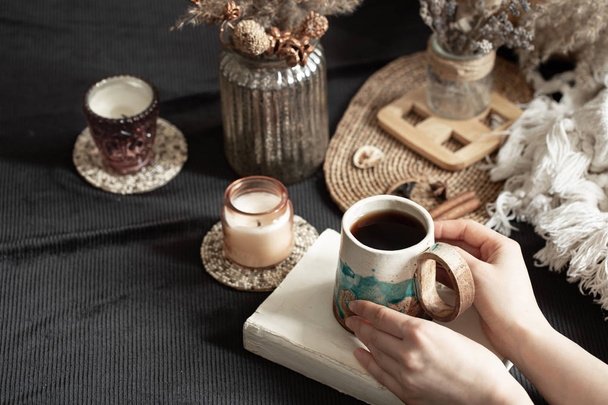 Still life with a beautiful Cup and female hands. An intimate, homely atmosphere. decorative items. - Photo, Image