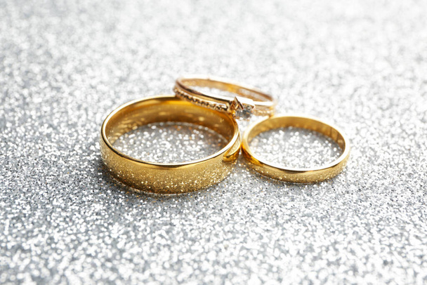Belos anéis de casamento e noivado no fundo de prata
 - Foto, Imagem