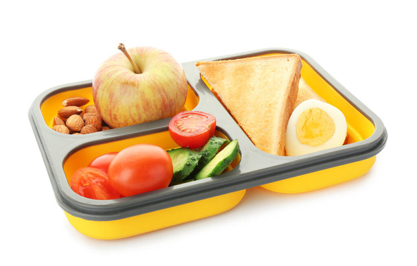 Boîte à lunch scolaire avec une nourriture savoureuse sur fond blanc
 - Photo, image
