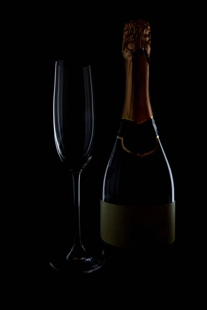 Empty champagne glass tea bottle on black background, magazine and commercial photo with place for text or design, festival and festive food and drink photography - Fotoğraf, Görsel
