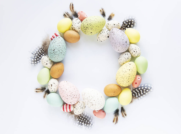 Easter decoration. Circle Easter frame of  colored easter eggs  on white background  with space for text. Top view, flat lay - Valokuva, kuva