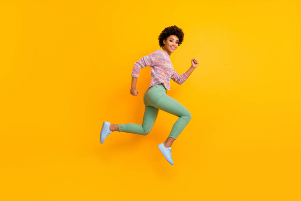 Full length profile side photo of funky dreamy cheerful afro american girl jump run hurry want black friday discount wear green good fall spring outfit isolated over shine color background - Photo, image