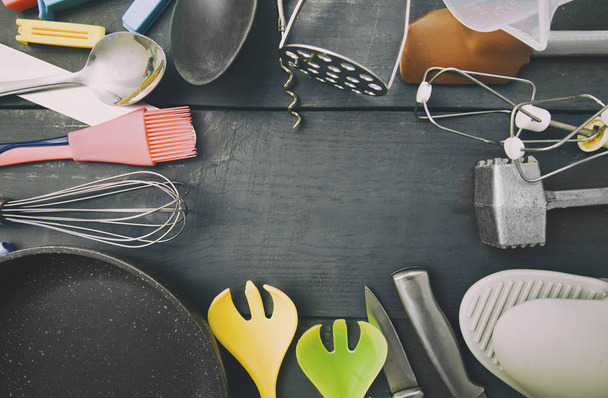 Lots of different kitchen utensils on the wooden table - Fotoğraf, Görsel