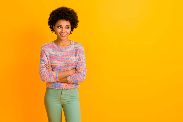 Portrait of attractive modern afro american girl cross hands listen her job friend look copy space wear stylish green trousers isolated over shine color background - Photo, Image