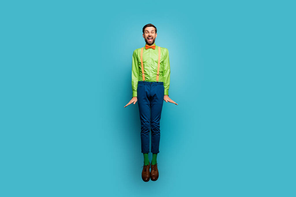 Full length body size view of his he nice attractive funky cheerful cheery crazy guy jumping having fun isolated on bright vivid shine vibrant blue green teal turquoise color background - Foto, Imagem