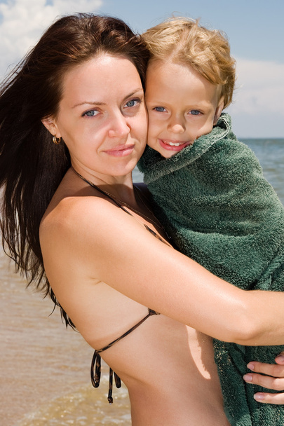 Giovane donna con il suo piccolo figlio in spiaggia
 - Foto, immagini