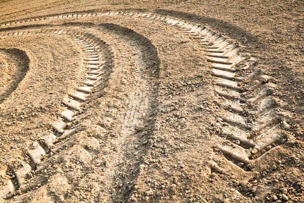 Big wheel tracks on the ploughed field. - Photo, Image