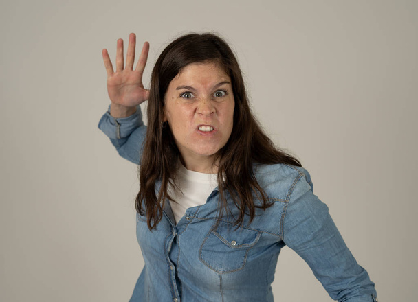 Facial expressions and emotions. Portrait of Young attractive caucasian woman with an angry glaring face. Looking mad and crazy shouting and making furious gestures. Isolated on neutral background. - Foto, Bild