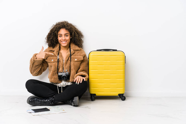 Young african american woman ready for a travel person pointing by hand to a shirt copy space, proud and confident - Photo, Image