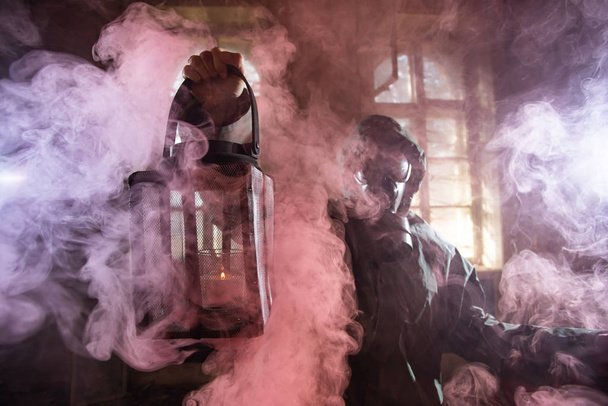 Post apocalyptic survivor in gas mask in the smoke. Environmental disaster, armageddon concept. - Photo, Image