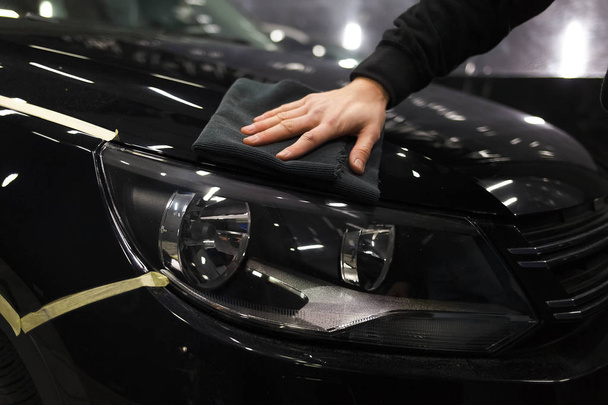 Car care concept. Detailing master polishes a car - Photo, Image
