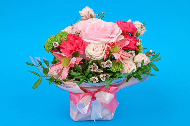 Bouquet of flowers on a blue background. Congratulations to the women. Flowers are loved. Place for writing. Flat lay - Photo, image