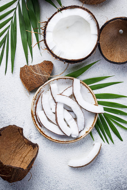 Sliced coconut and palm leaves - Photo, Image