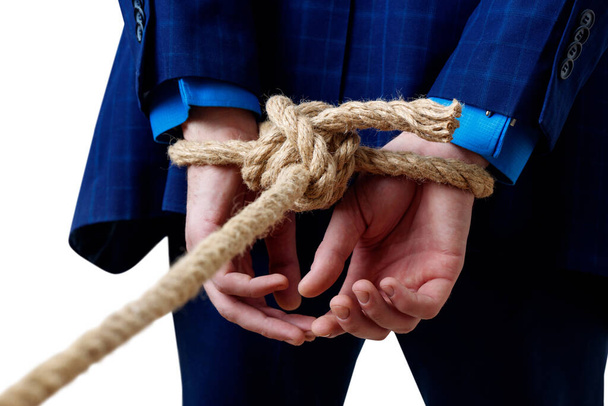 Close-up view on tied hands of businessman in blue suit. - Photo, Image