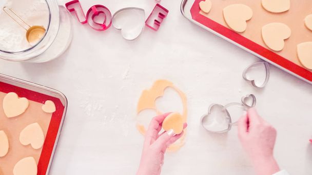 Flat lay. Step by step. Cutting out shapes from sugar cookie dough with cookie cutters. - Photo, Image