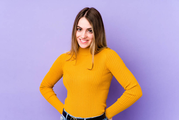 Young caucasian woman isolated on purple background happy, smiling and cheerful. - Fotografie, Obrázek