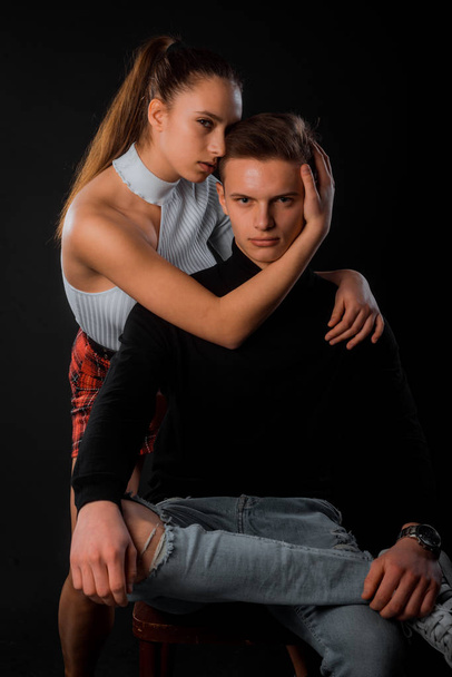 Studio fashion shot of passionate guy and girl cuddling together - Foto, afbeelding