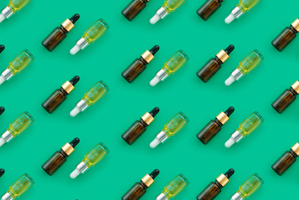 Glass bottles with essential oils assorted in geometry pattern - Фото, зображення