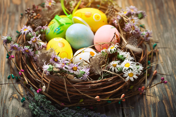 Happy Easter. Congratulatory easter background. Easter eggs and flowers. Background with copy space. Selective focus. Top view. - Photo, Image