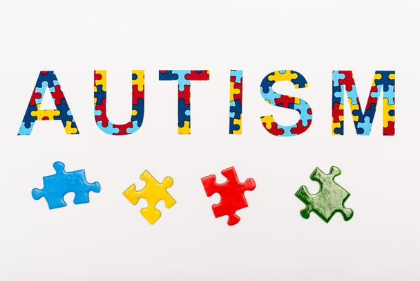Top view of Autism puzzle lettering on white  - Foto, imagen