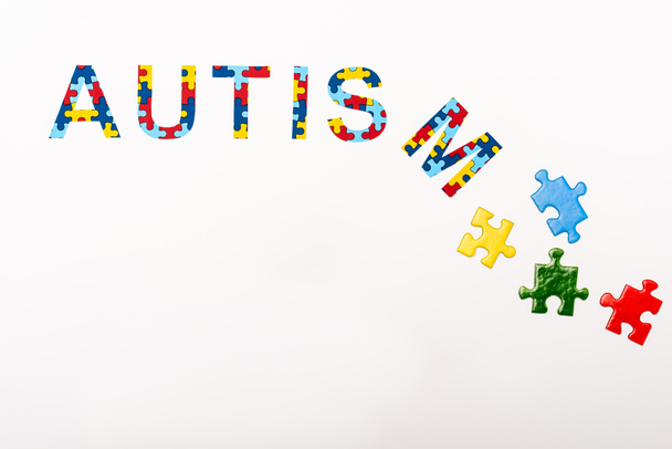 Top view of Autism puzzle inscription on white background - Foto, afbeelding
