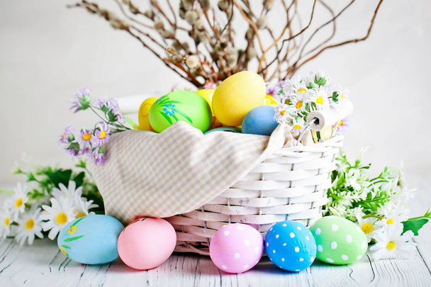 Happy Easter. Congratulatory easter background. Easter eggs and flowers. Background with copy space. Selective focus. - Photo, Image