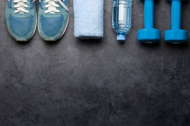 Fitness equipment on a stone background. Top view flat lay with copy space - Foto, afbeelding