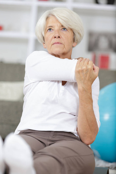a mature woman exercising at home - Photo, image