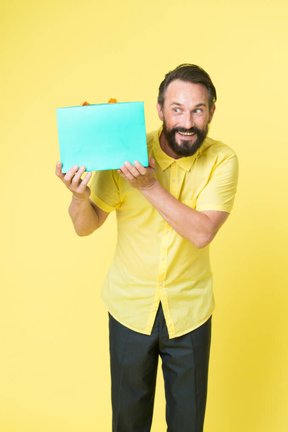 Put your purchase in gift bag. Fashion buyer hold shopping bag. Happy man with paperbag. Purchase bought on sale. Packaging purchase. Black Friday. Cyber Monday. Purchase order, copy space - Photo, image