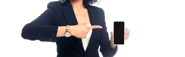 Cropped view of african american woman pointing at smartphone isolated on white, panoramic shot - Фото, изображение