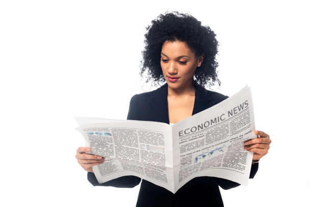 Front view of beautiful african american businesswoman reading newspaper isolated on white - Fotó, kép