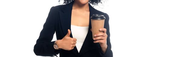 Gewassen beeld van Afro-Amerikaanse tonen duim omhoog en houden wegwerp kopje koffie geïsoleerd op wit - Foto, afbeelding