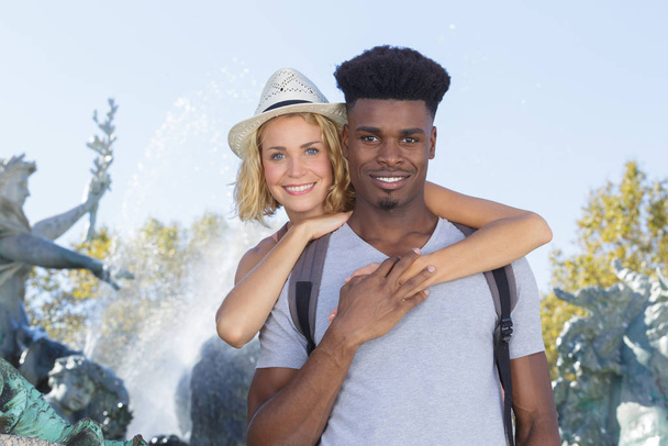 portrait of young mixed race couple by fountain - Foto, Imagem